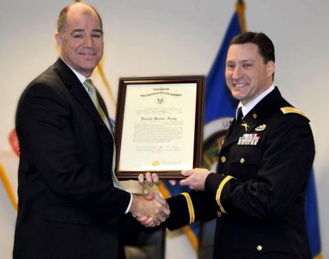 Mr. Douglas K. Wiltsie presents a Certificate of Promotion to COL Kevin Vanyo during his promotion ceremony held Friday, January 9, 2015. Click on the image to view more photos