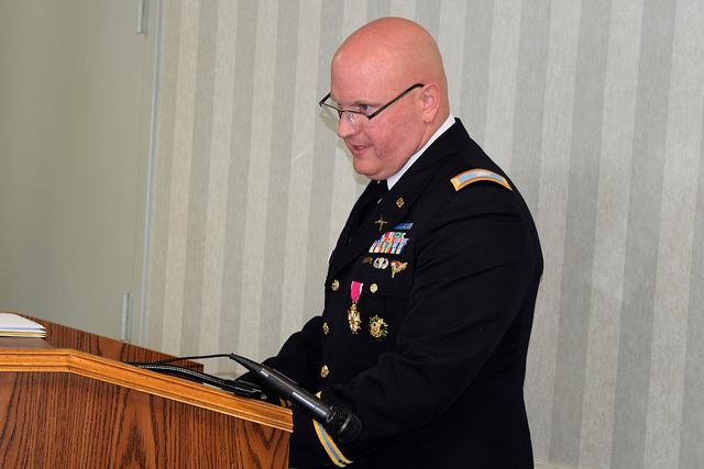 Soldier speaks behind podium.