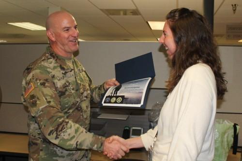 Col. Harris presents civilian employee with certificates of appreciation